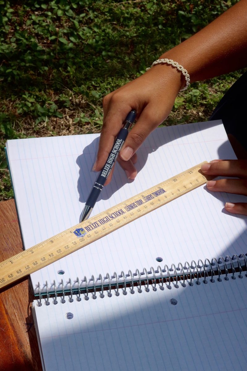 A BHS-branded pen and ruler on a student notebook