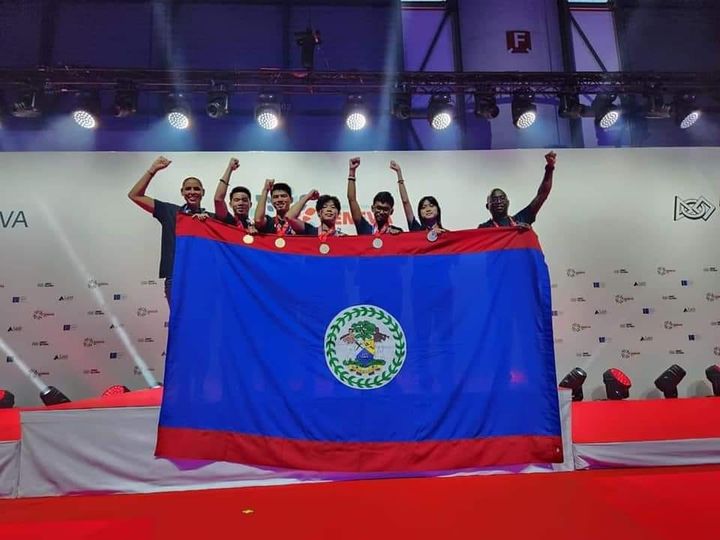 BHS robotics team holding the Belize flag after winning gold at the 2022 FIRST Global Challenge in Geneva